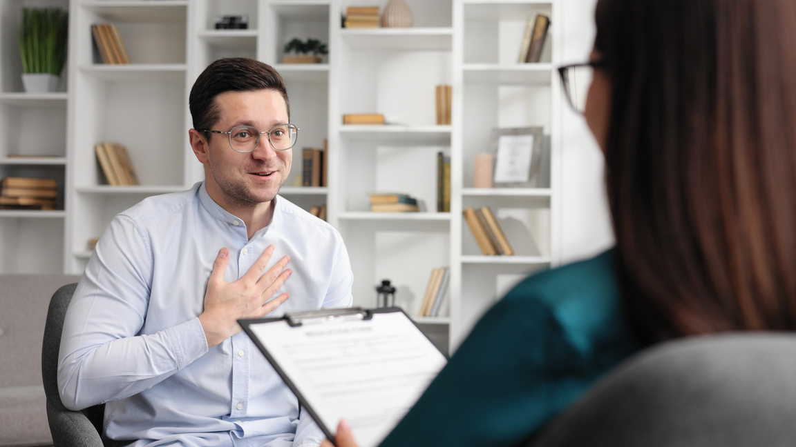 A happy male patient thanks his psychologist for his help. Finished positive result of psychological consultation, mental health.